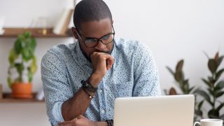 man annoyed at laptop