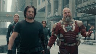 US Agent, Bucky, Ghost, and Red Guardian walking through a street filled with rubble in Marvel's Thunderbolts movie