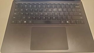 black laptop on white table