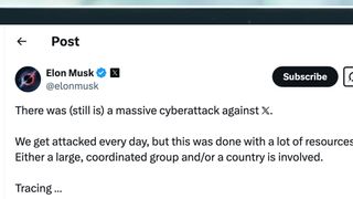 A laptop screen showing an X post from Elon Musk about a massive cyberattack