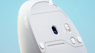 The underside of the Asus Fragrance Mouse on a blue background