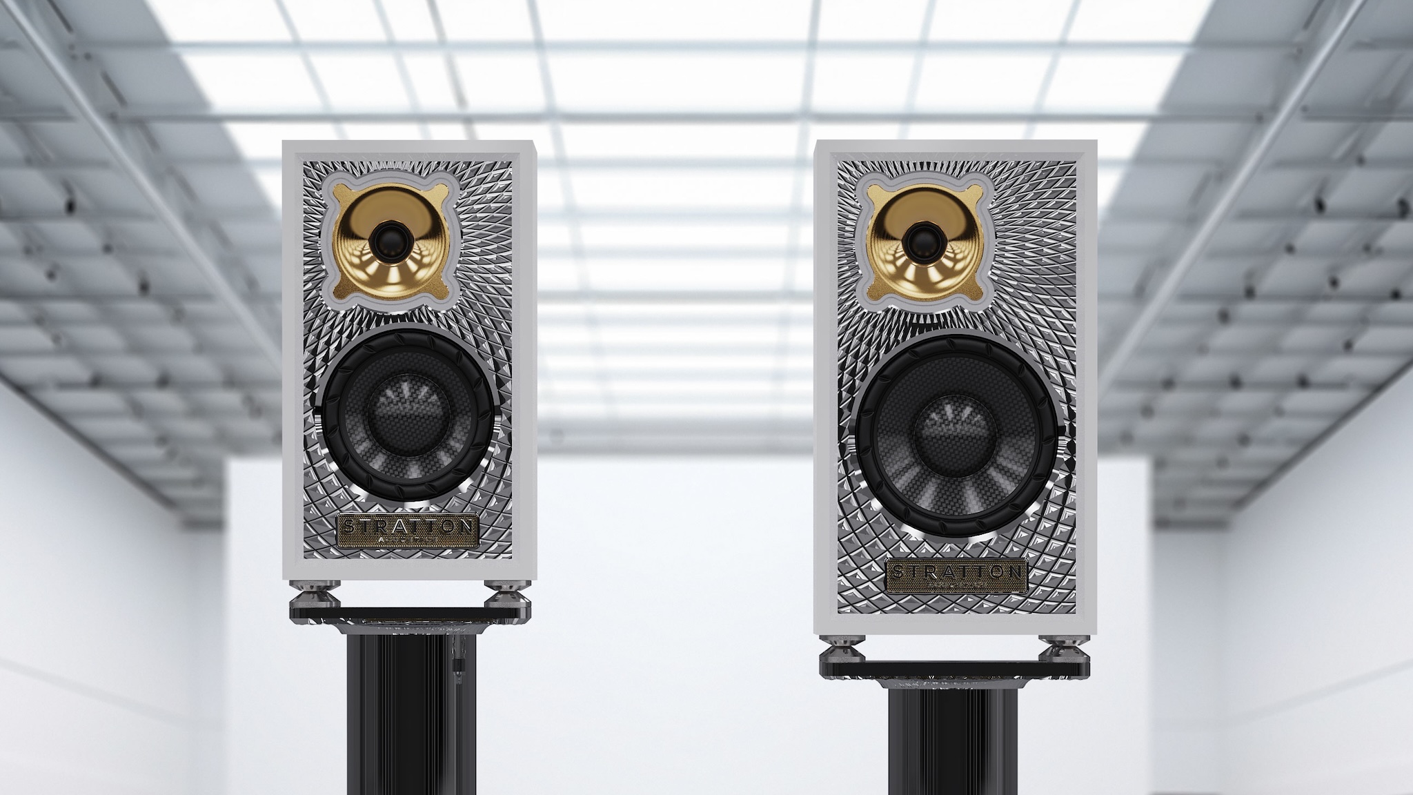 Stratton Acoustics Element 6 and Element 8 speakers on stands in a grey and white brightly light room
