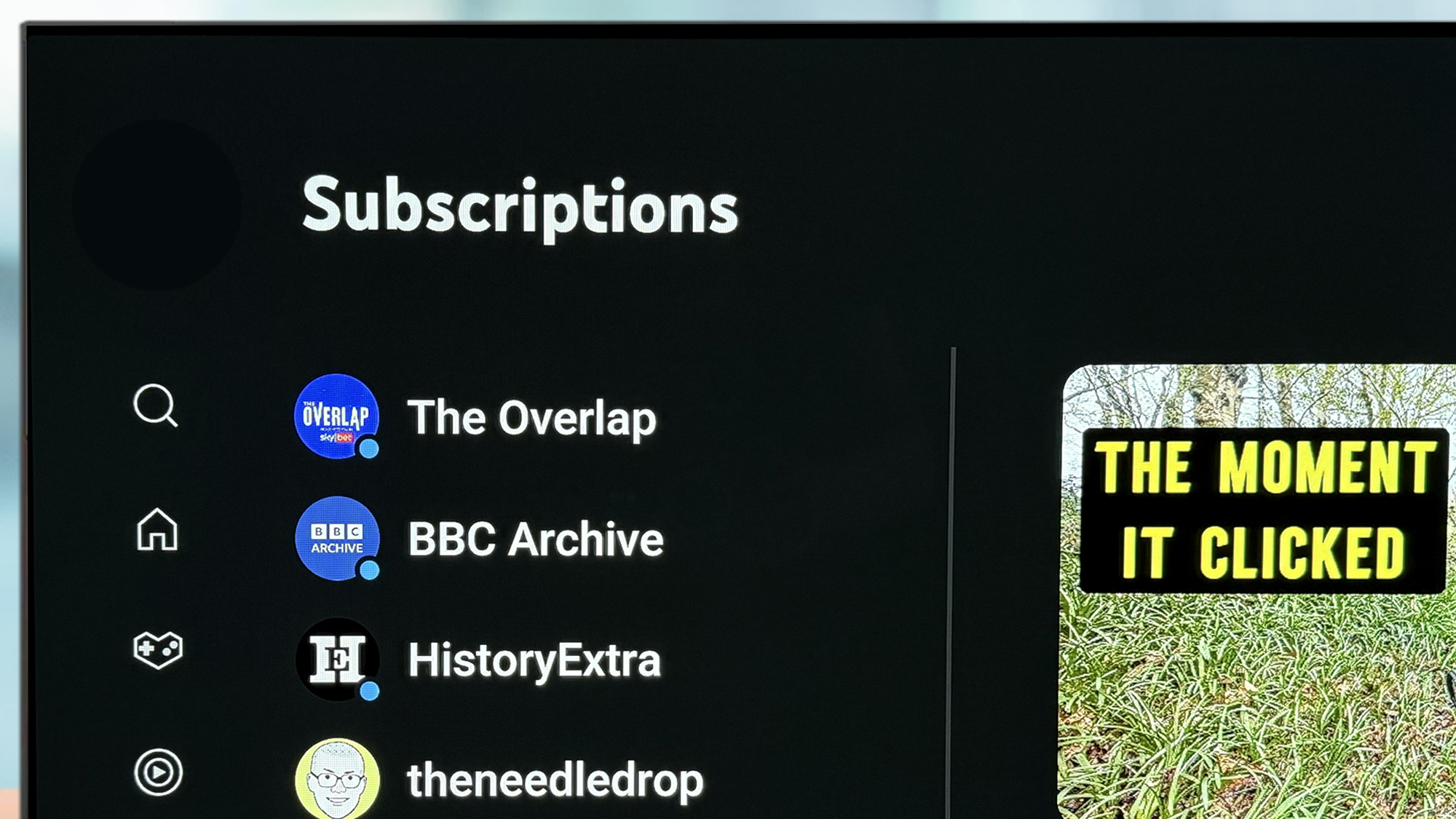 A TV screen showing the subscriptions list in the Youtube app