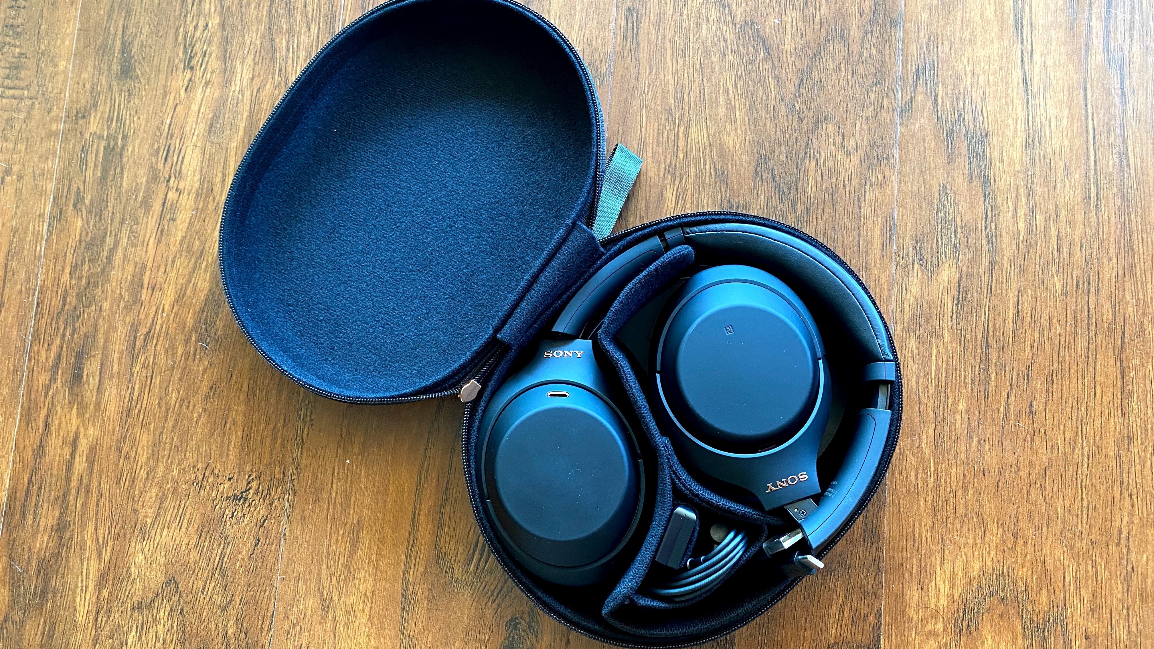 the Sony WH-1000XM4 in their carrying case