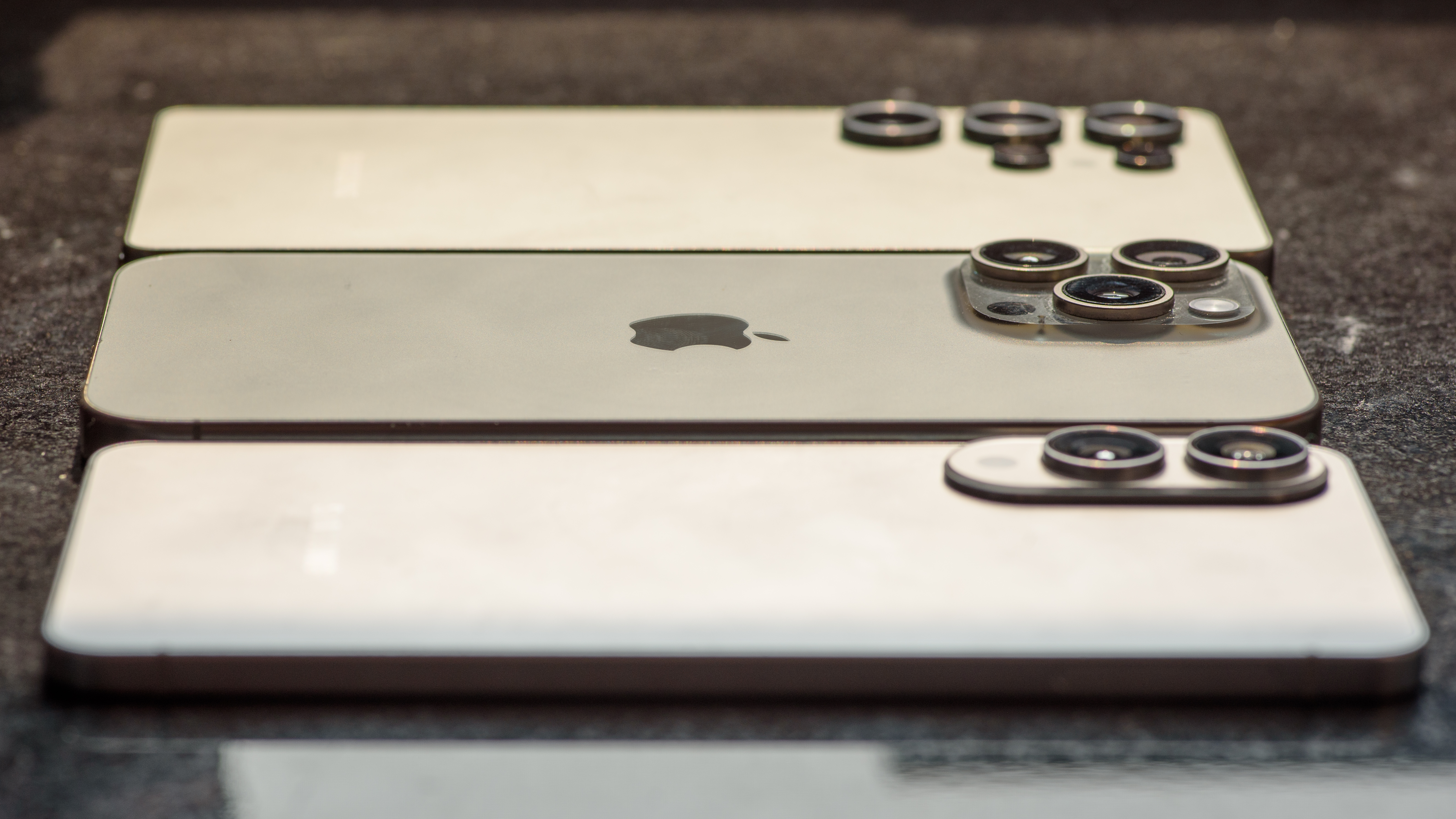 The Samsung Galaxy S25 Edge and S25 Ultra with an iPhone 16 Pro Max in between