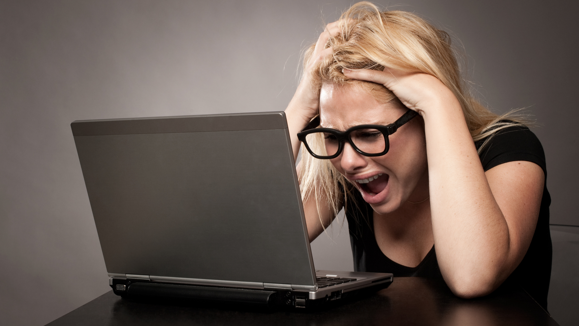 Person looking angry at their laptop