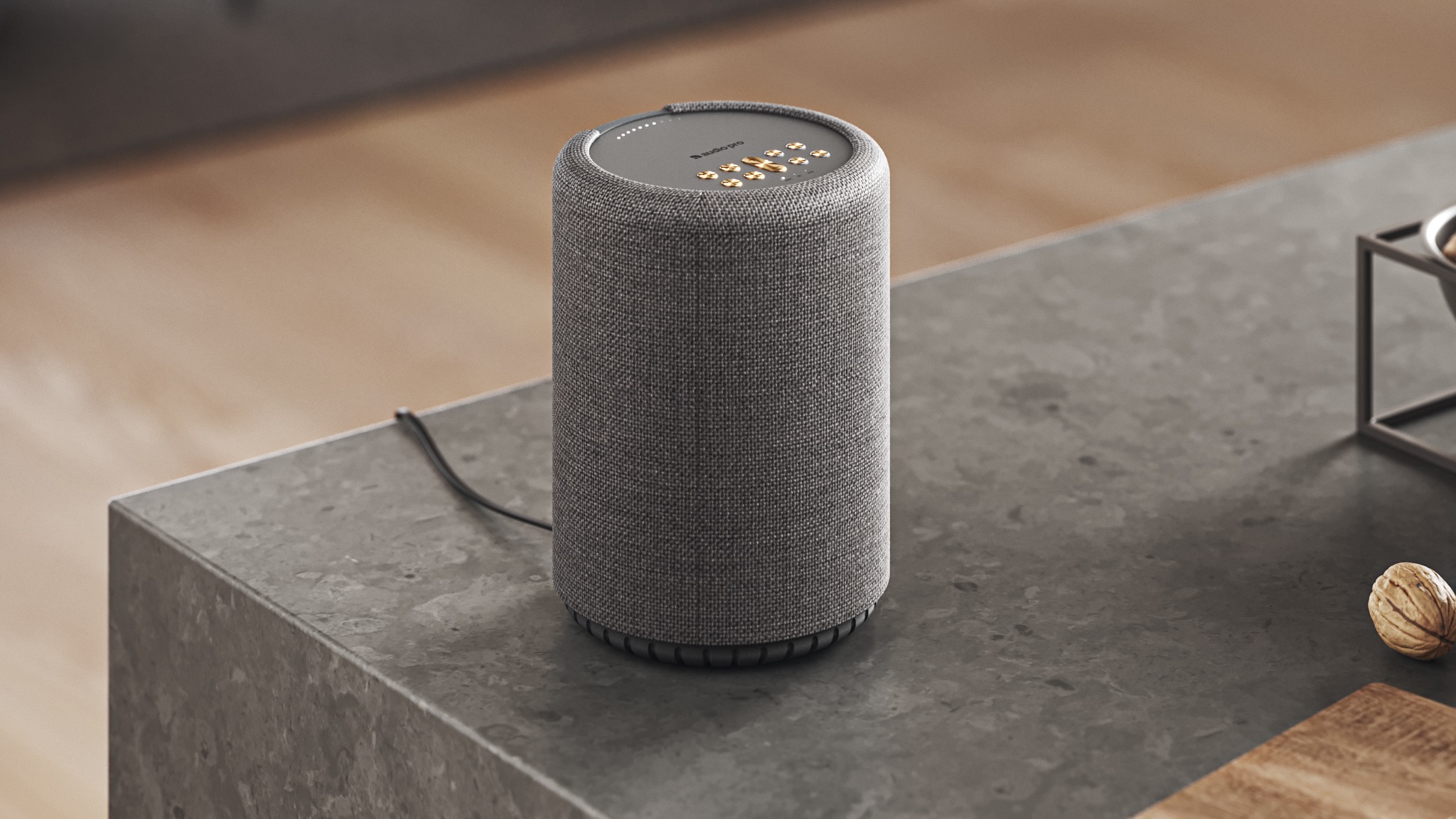 An Audio Pro A10 MkII W speaker atop a granite-finish sideboard or unit