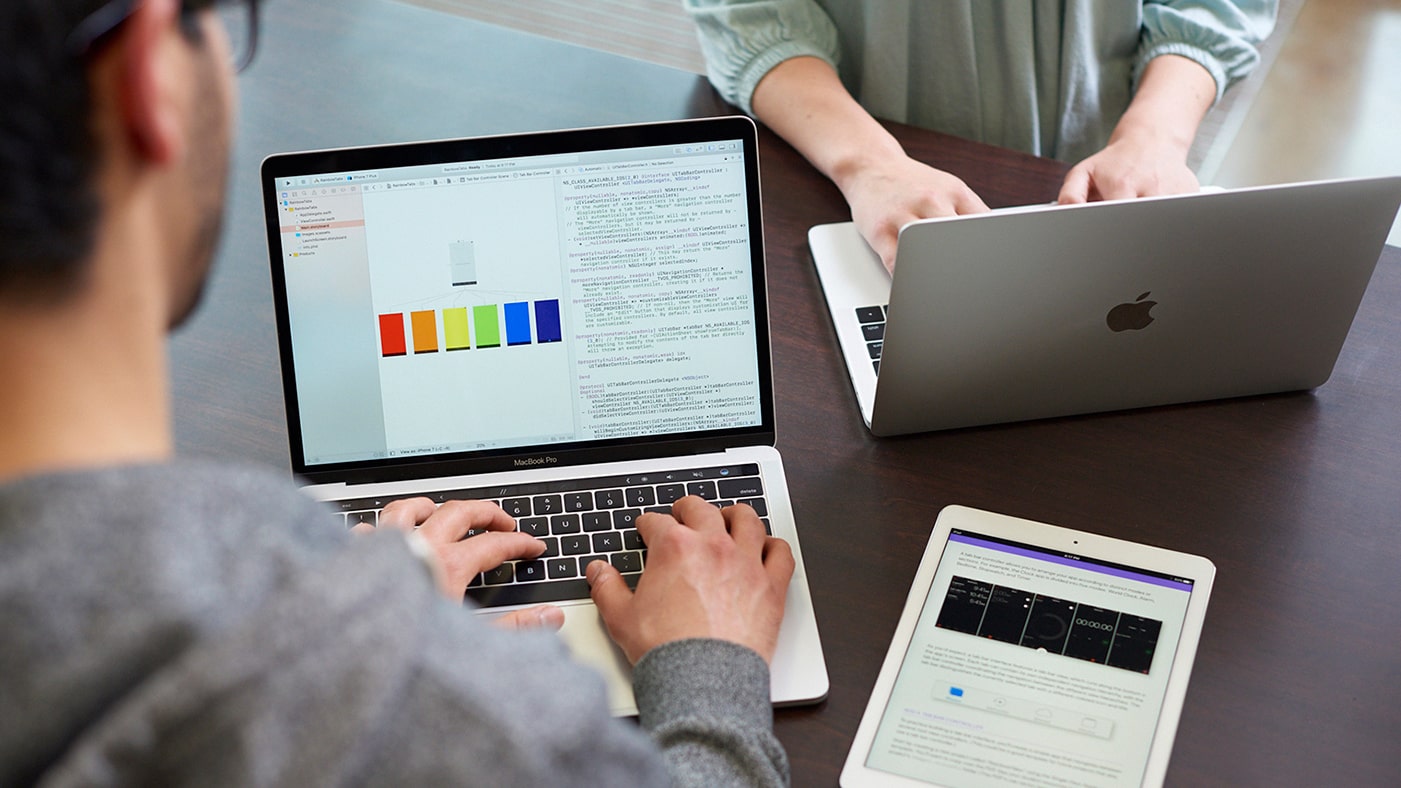 A person using an Apple MacBook.