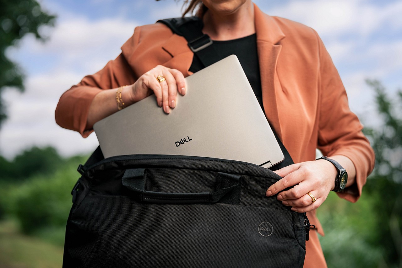 Dell Plus Laptop being taken out of a bag