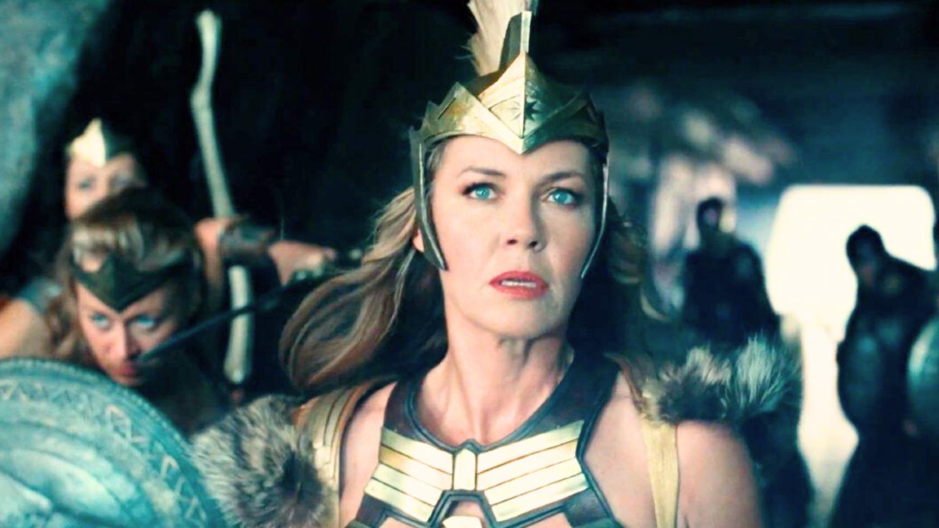 Connie Nielsen wears armor and holds a shield