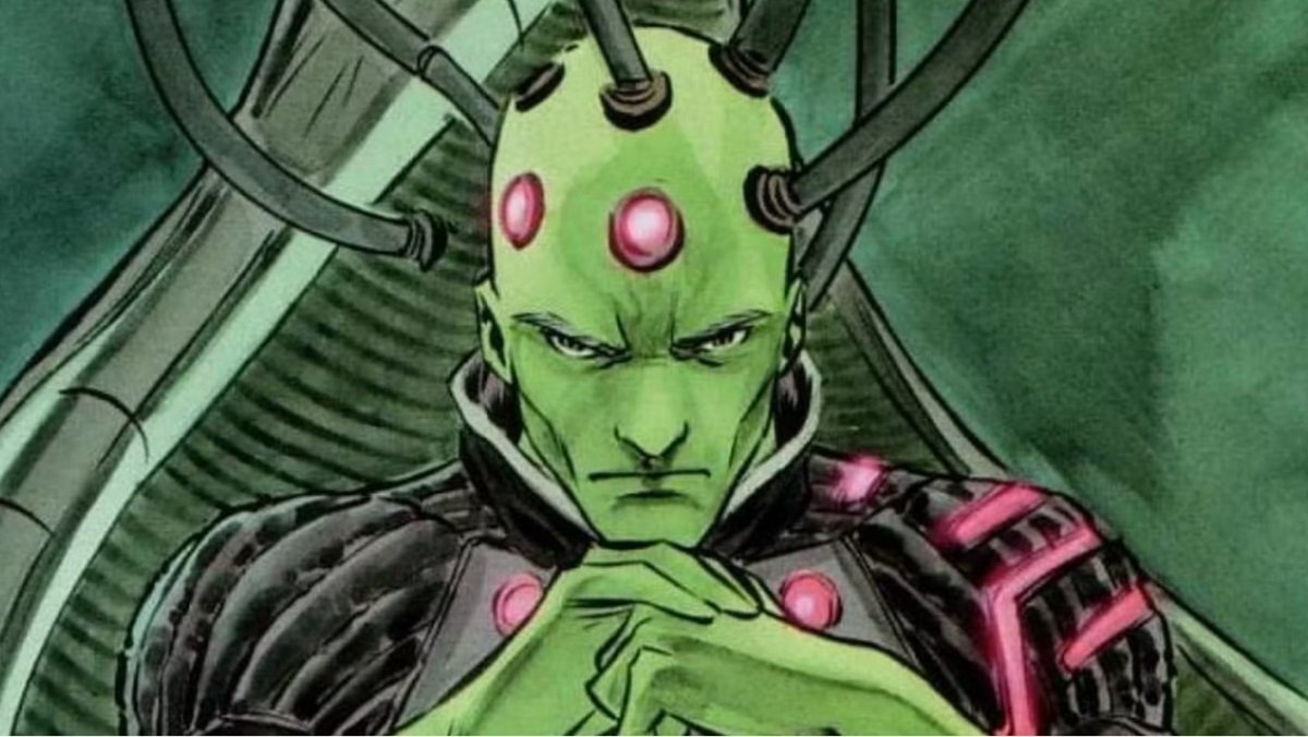 A screenshot of Brainiac sitting with his hands clasped and his head attached to wires in a DC comic book panel