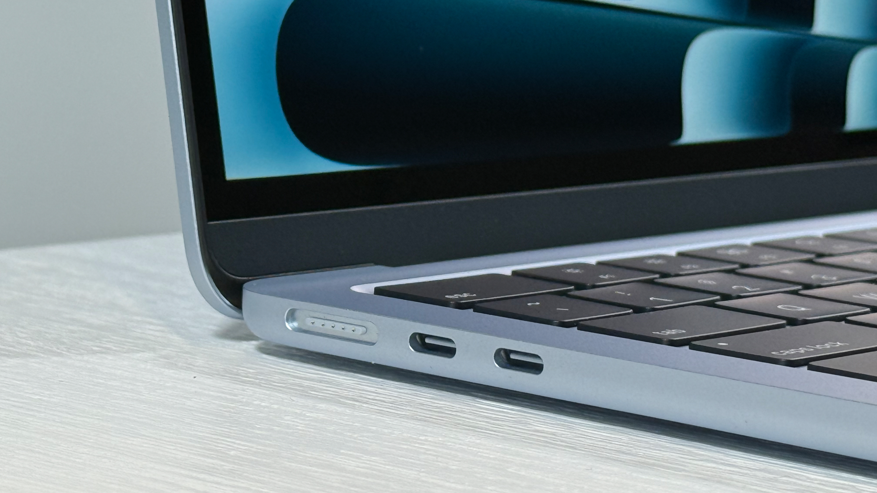 Up-close MagSafe and USB ports on 13-inch MacBook Air M4 in Sky Blue