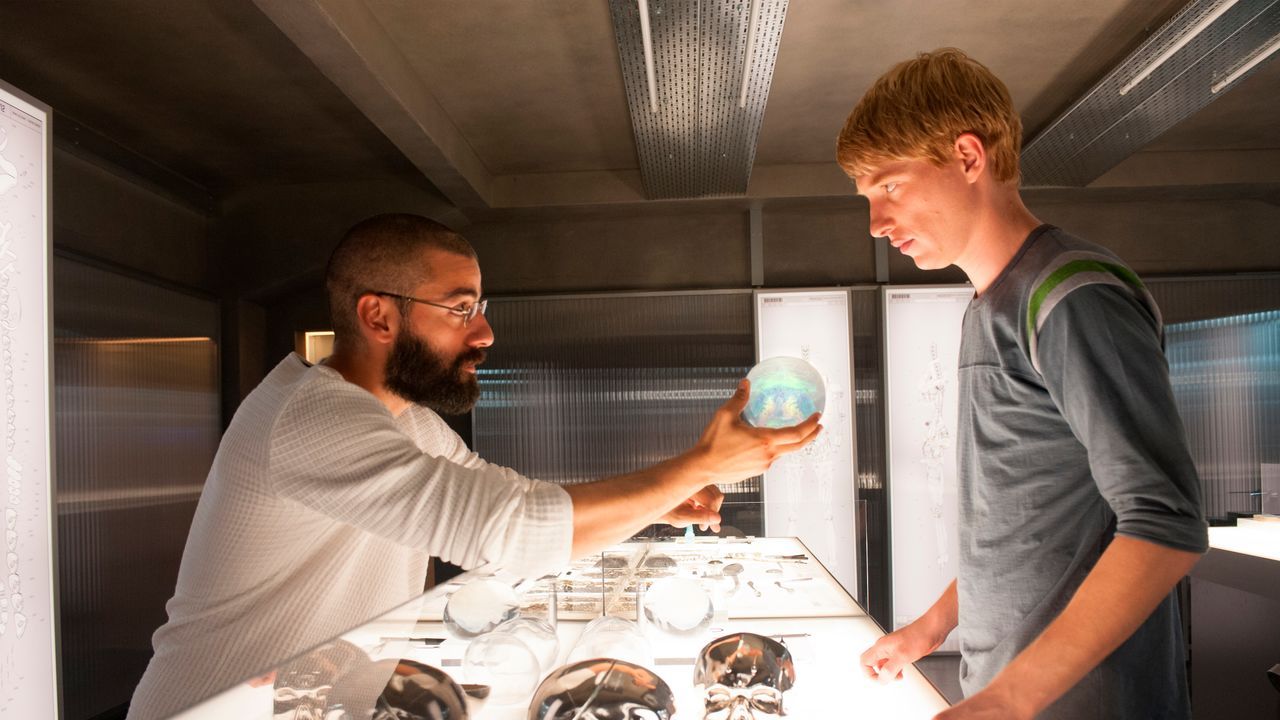 A still from the movie ex machina showing characters caleb and nathan handling bits of tech