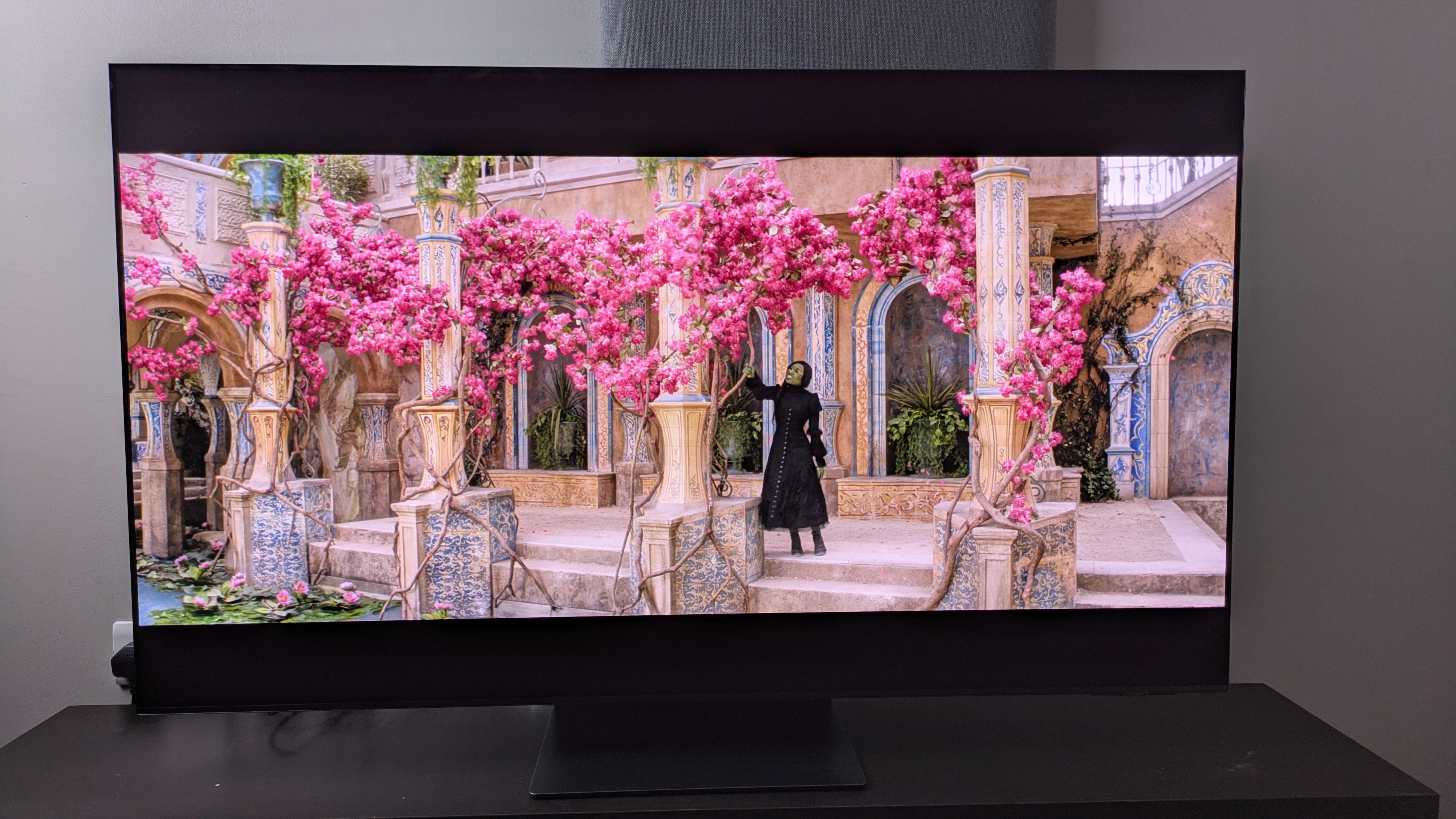 Samsung S95F with Elphaba from Wicked on screen