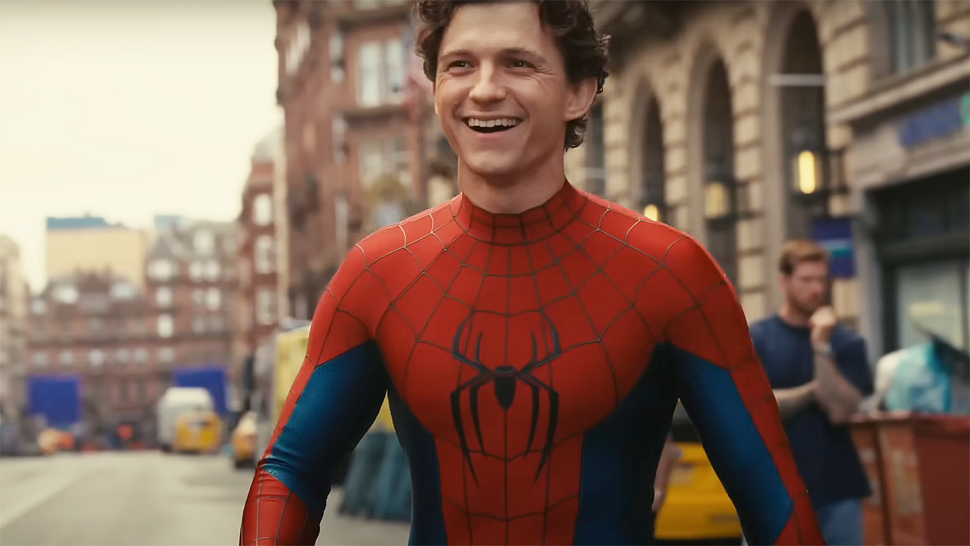 Tom Holland smiling and wearing his superhero costume in a Spider-Man: Brand New Day behind the scenes video