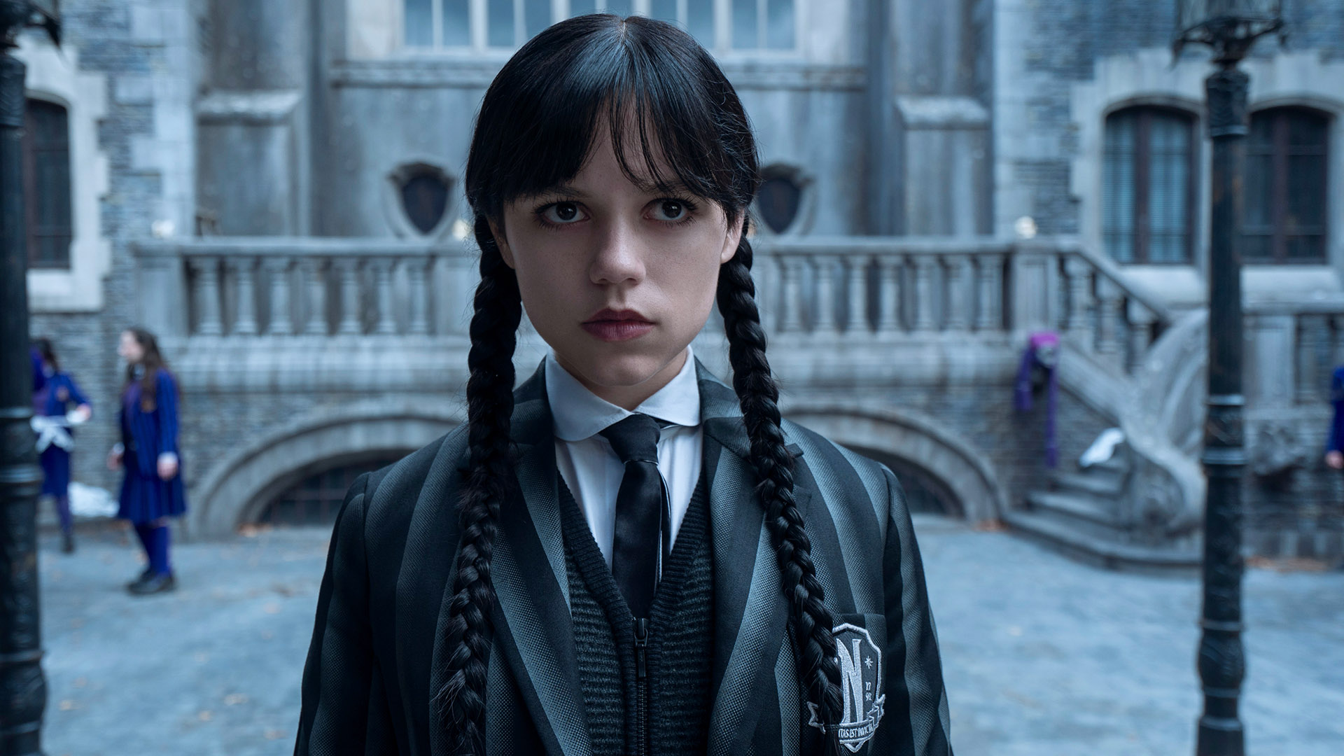 Jenna Ortega's Wednesday Addams standing in Nevermore Academy's courtyard in Wednesday season 2