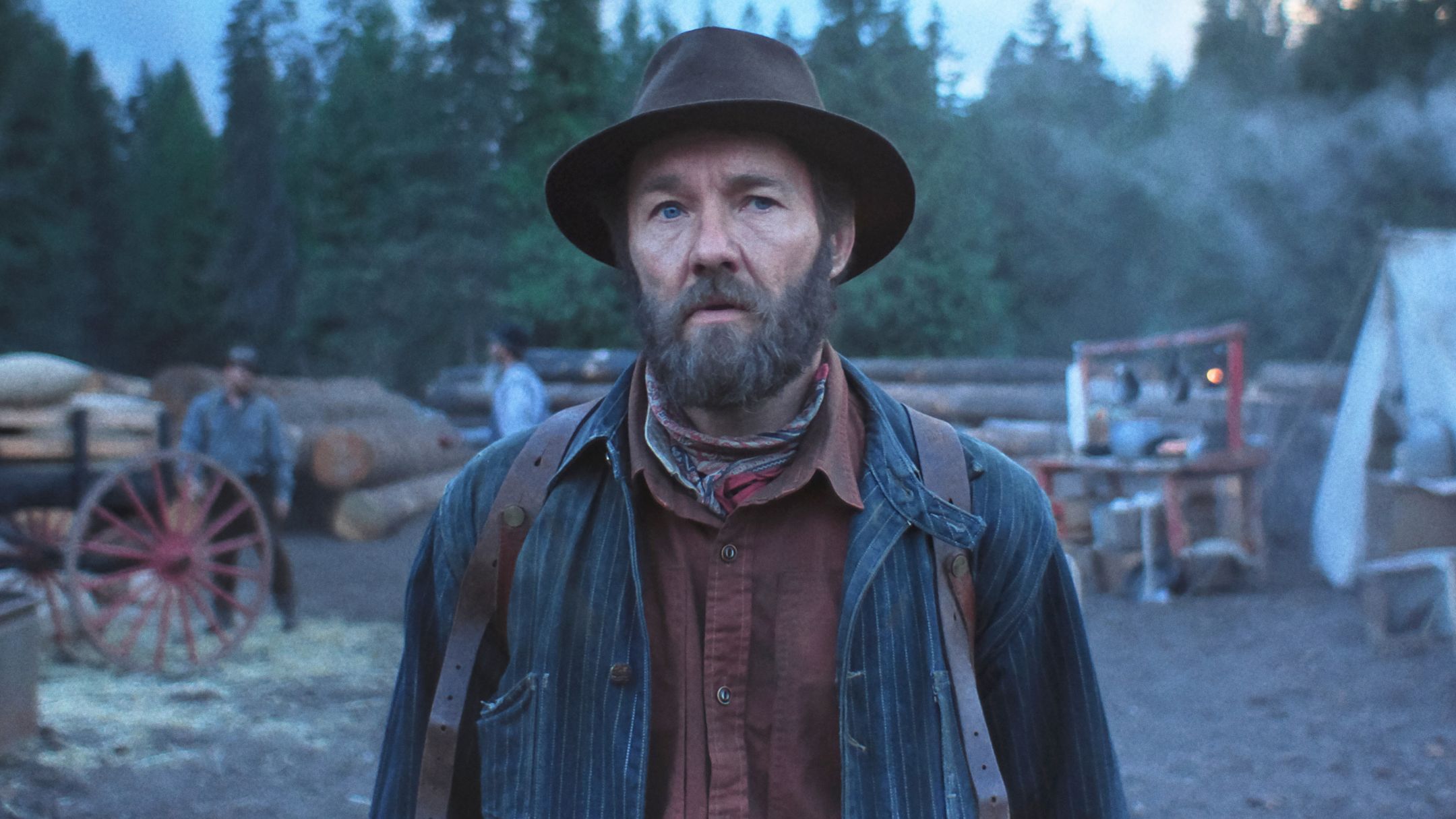 Joel Edgerton stands in a lumberjack's workplace