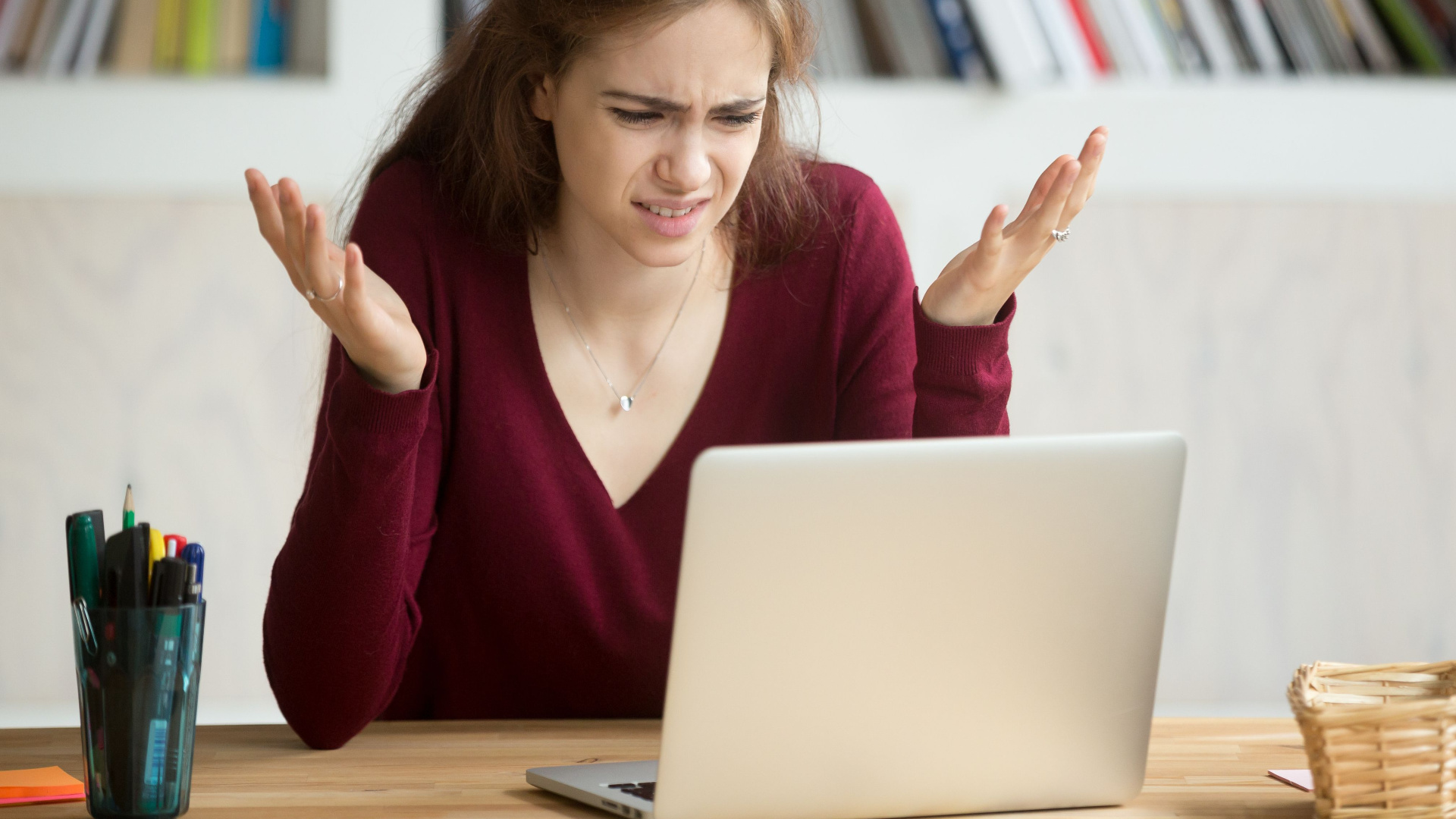 A woman getting frustrated by her Windows 11 laptop