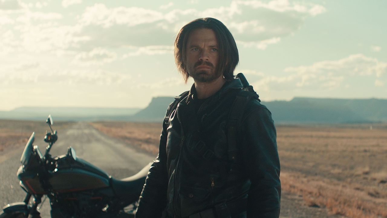 Bucky Barnes standing next to a motorbike on a freeway in Marvel's Thunderbolts movie
