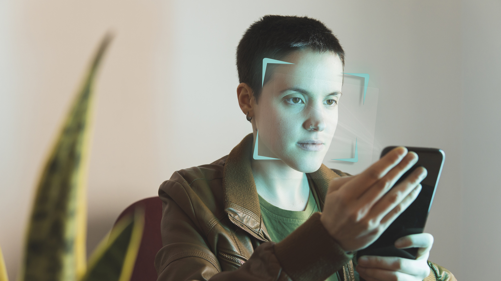 A person using a mobile device to verify their age via a facial scan