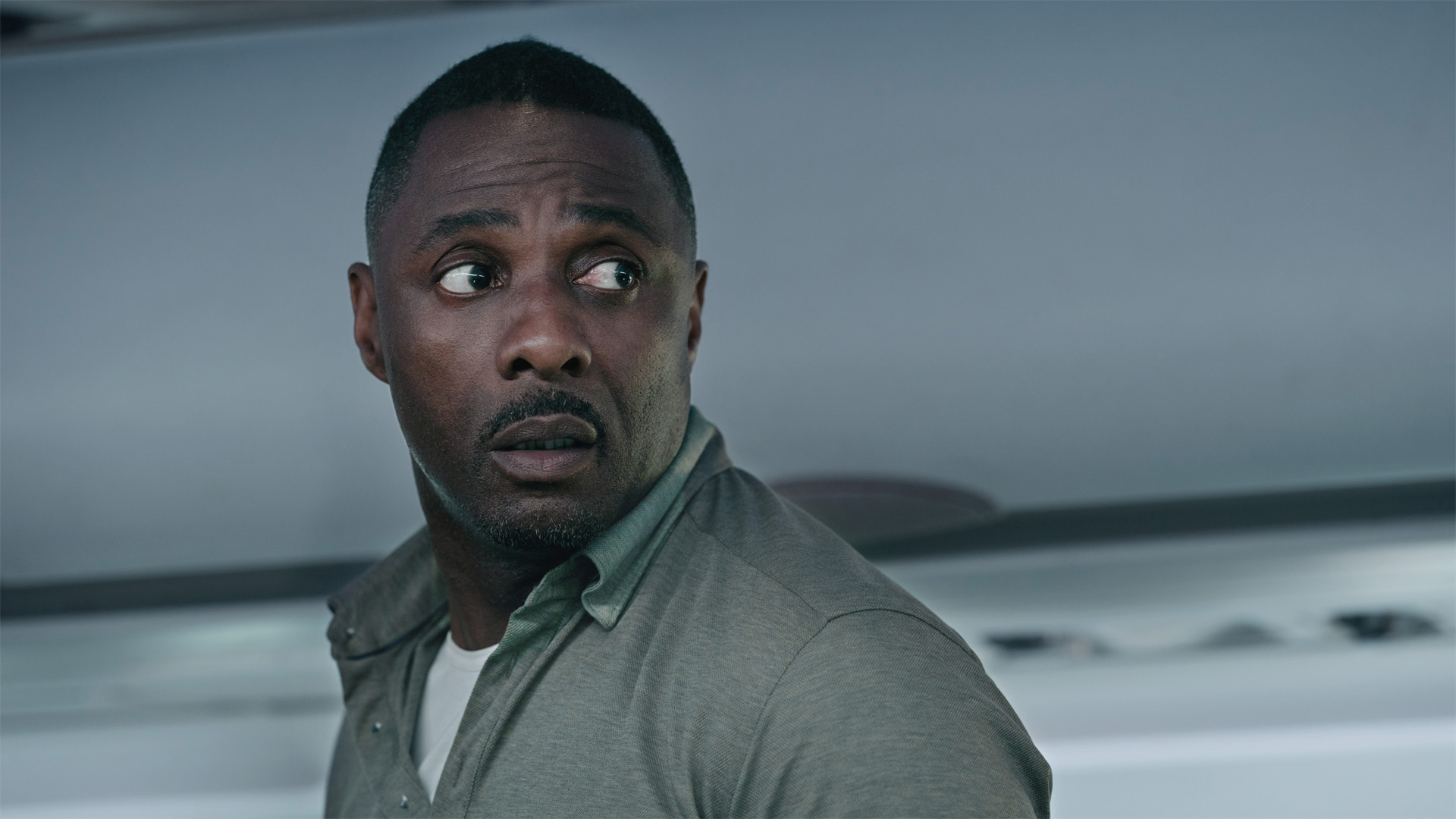 Sam Nelson (Idris Elba) standing on a plane in Hijack