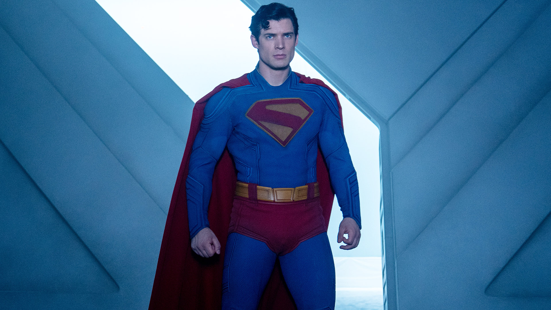 A stern-looking Clark Kent standing in the Fortress of Solitude in James Gunn's Superman movie