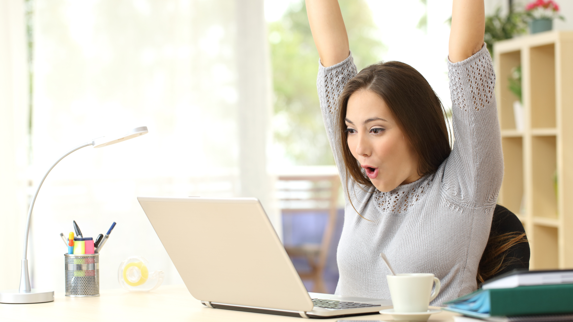happy woman using a Windows 11 laptop