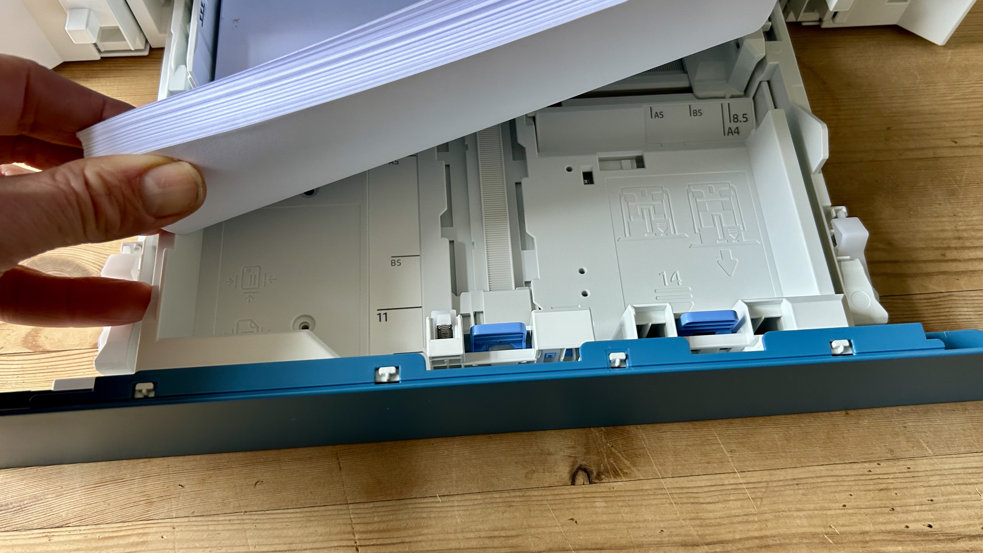 A laser printer with its paper tray open