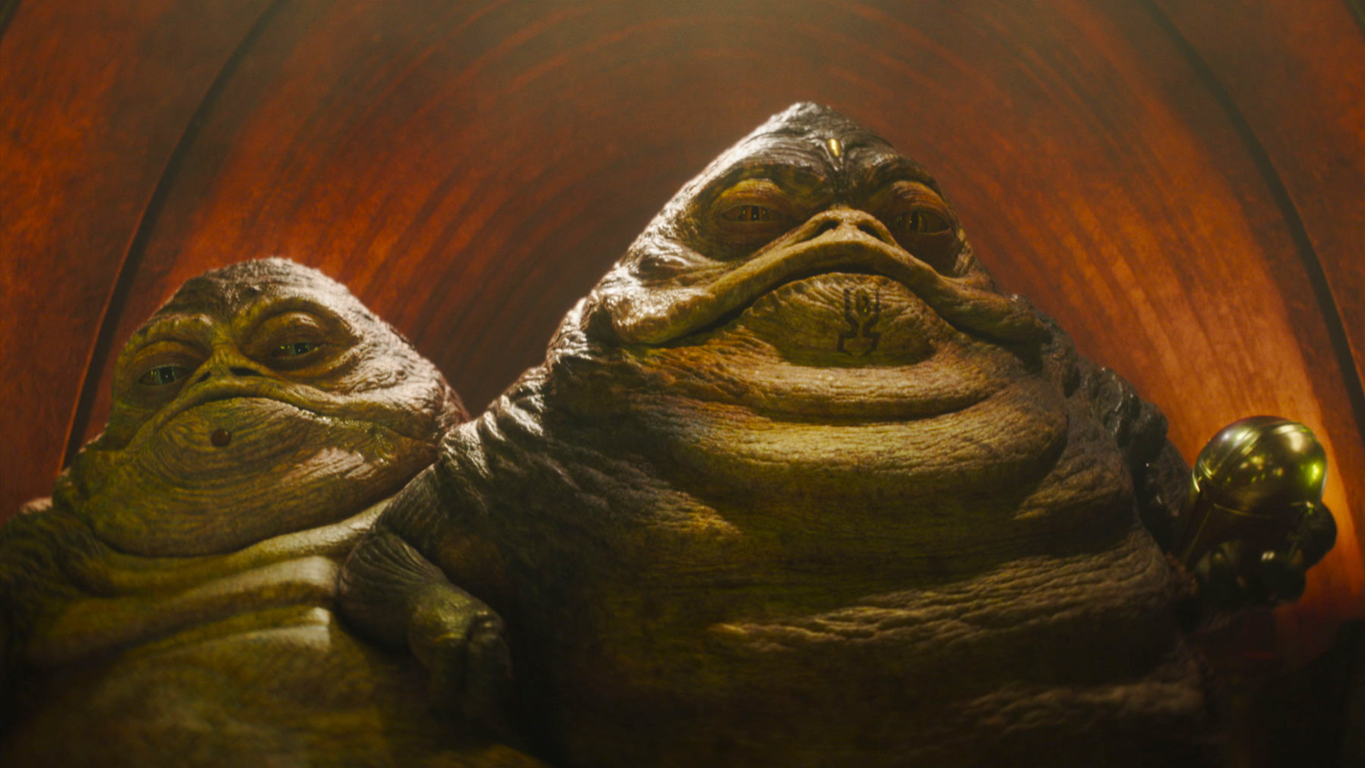 Sister and Brother Hutt looking at an off-camera Din Djarin in The Mandalorian and Grogu