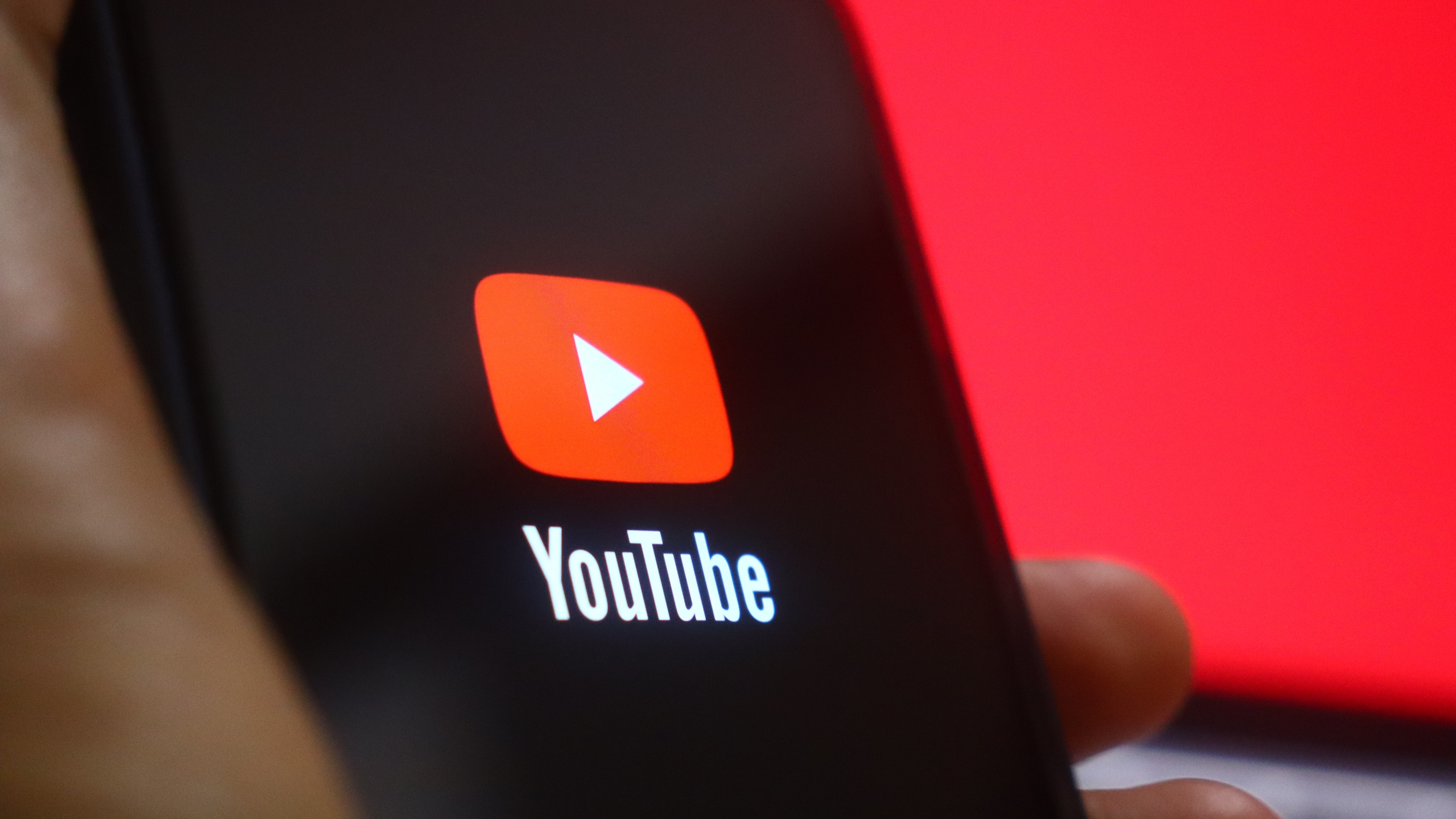 A close up of a smart phone with the YouTube app logo