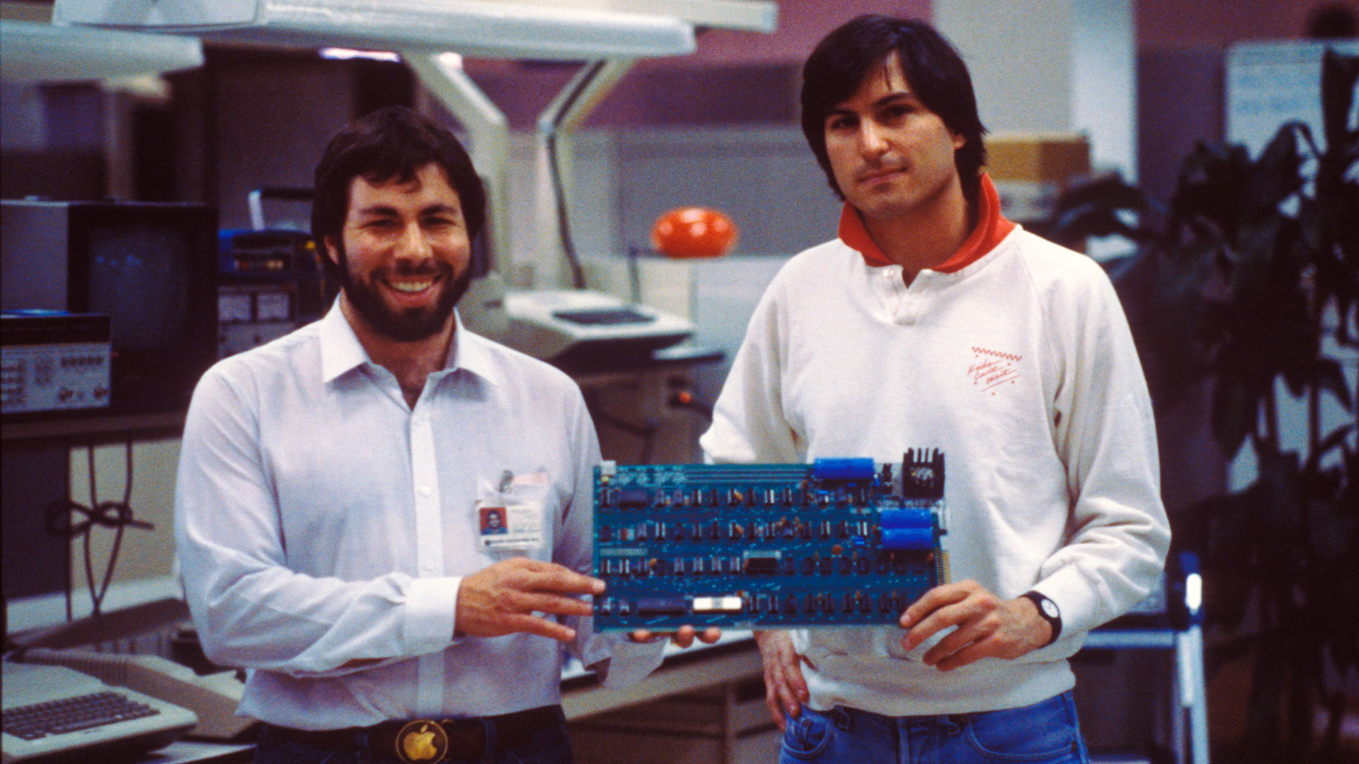 Apple co-founders Steve Jobs and Steve Wozniak with an early circuit board.