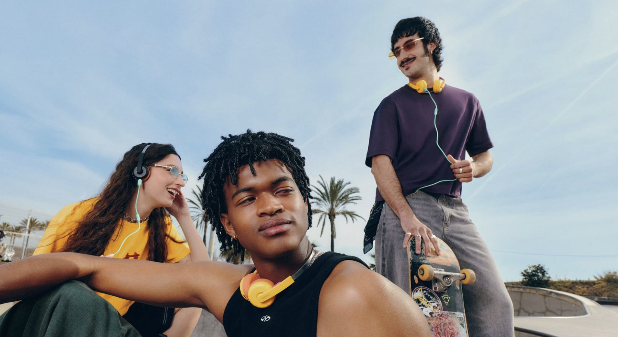 Philips audio products worn by a group of young people, with a skateboard
