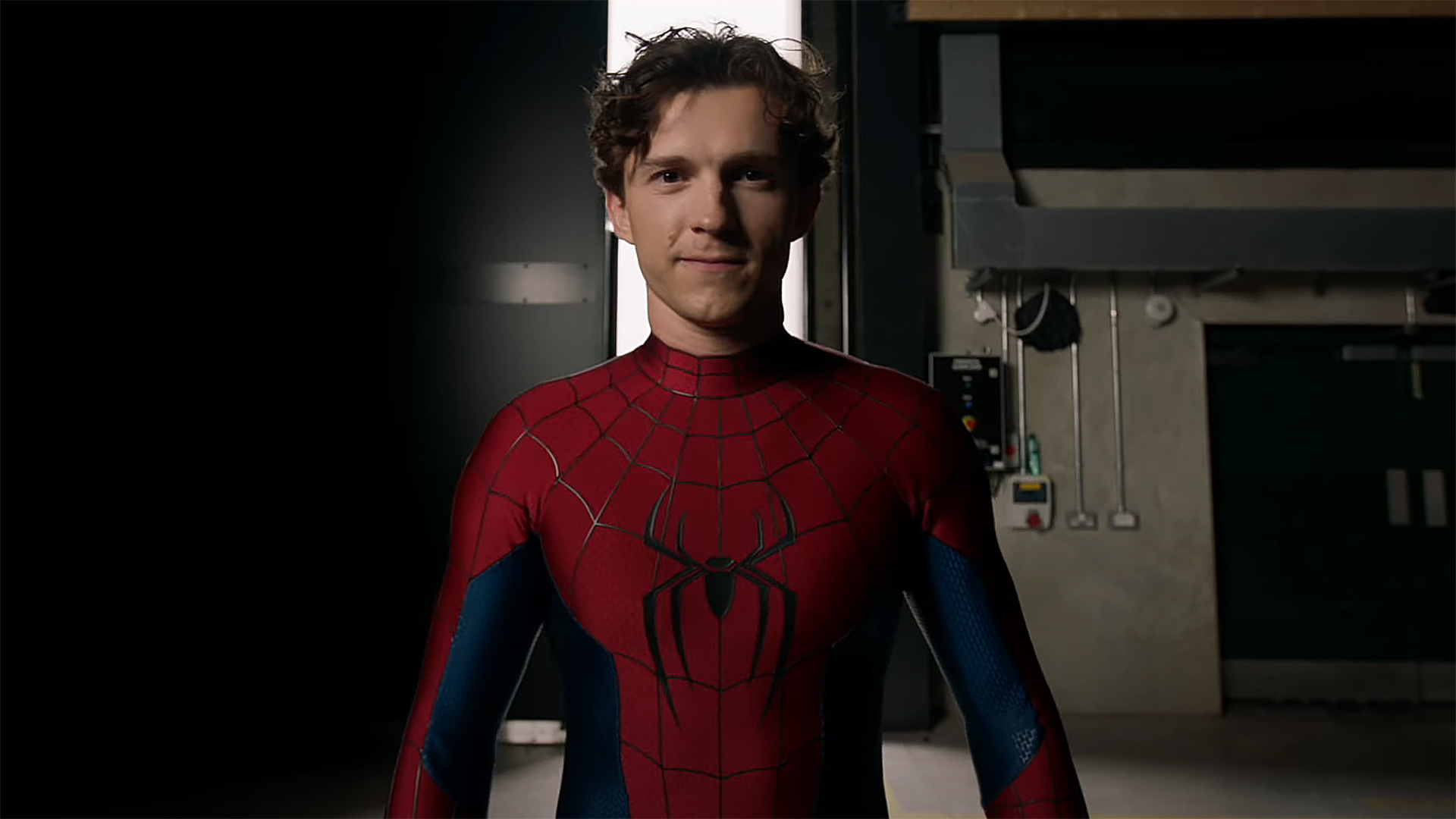 Tom Holland wearing his new Spider-Man suit and smiling in a behind the scenes video for Spider-Man: Brand New Day