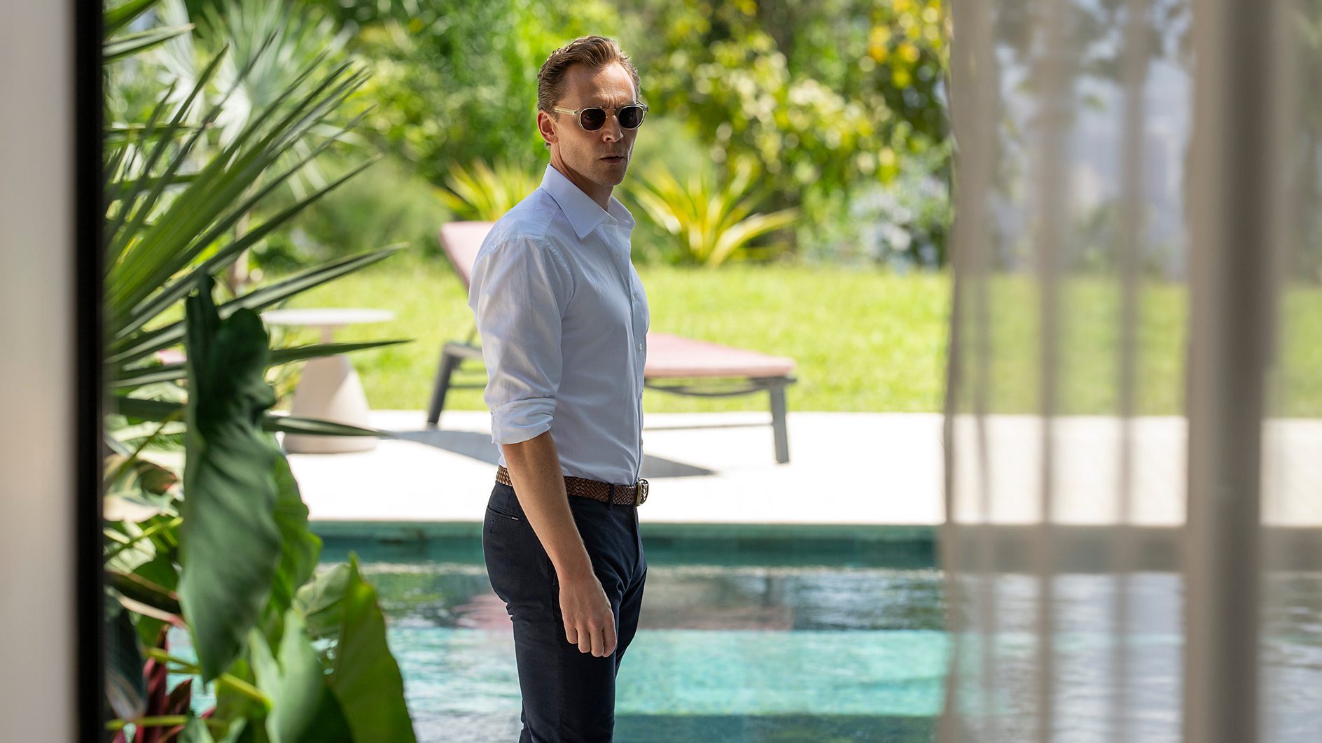 Tom Hiddleston as Jonathan Pine by a pool