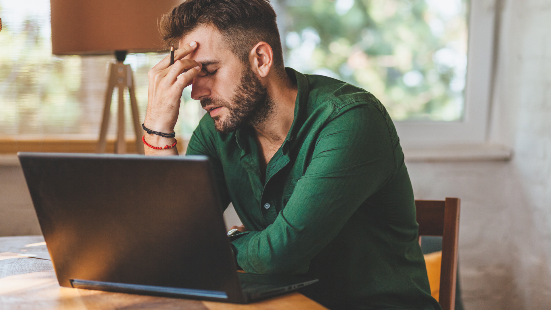 Man looking depressed at his Windows 11 laptop