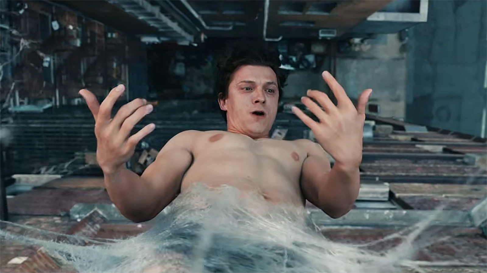 A shocked Peter Parker looking at his hands as he hangs upside down inside a web in Spider-Man: Brand New Day