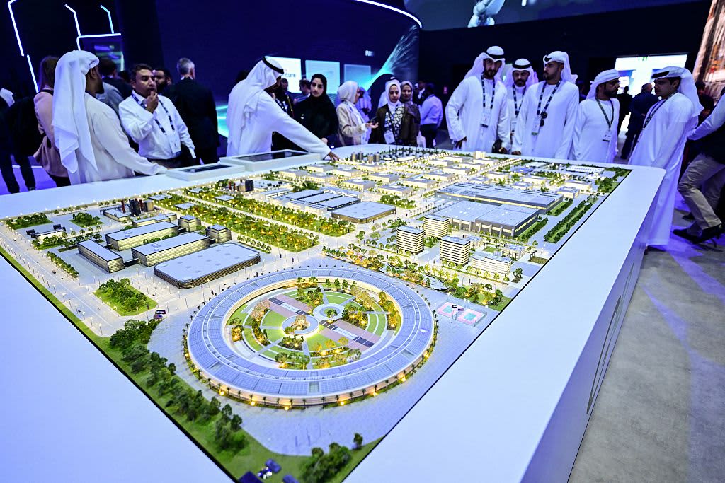 Guests look at a model of the largest data center in the UAE under construction in Abu Dhabi as the Stargate initiative, a joint venture between G42, Microsoft, and OpenAI, during the Abu Dhabi International Petroleum Exhibition & Conference (ADIPEC) in Abu Dhabi on November 3, 2025. (Photo by Giuseppe CACACE / AFP) (Photo by GIUSEPPE CACACE/AFP via Getty Images) 
