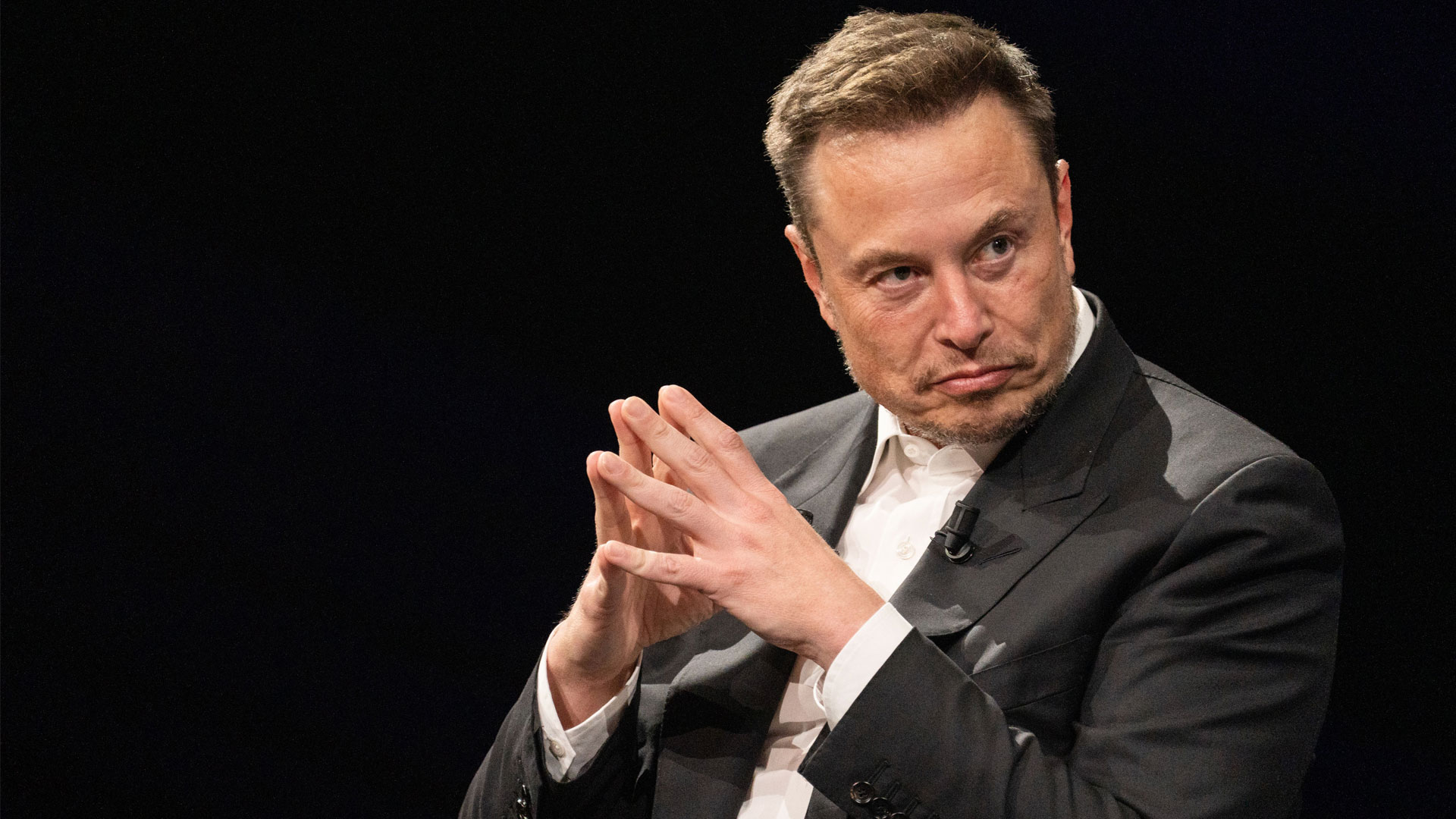 A photo of Elon Musk looking thoughtful