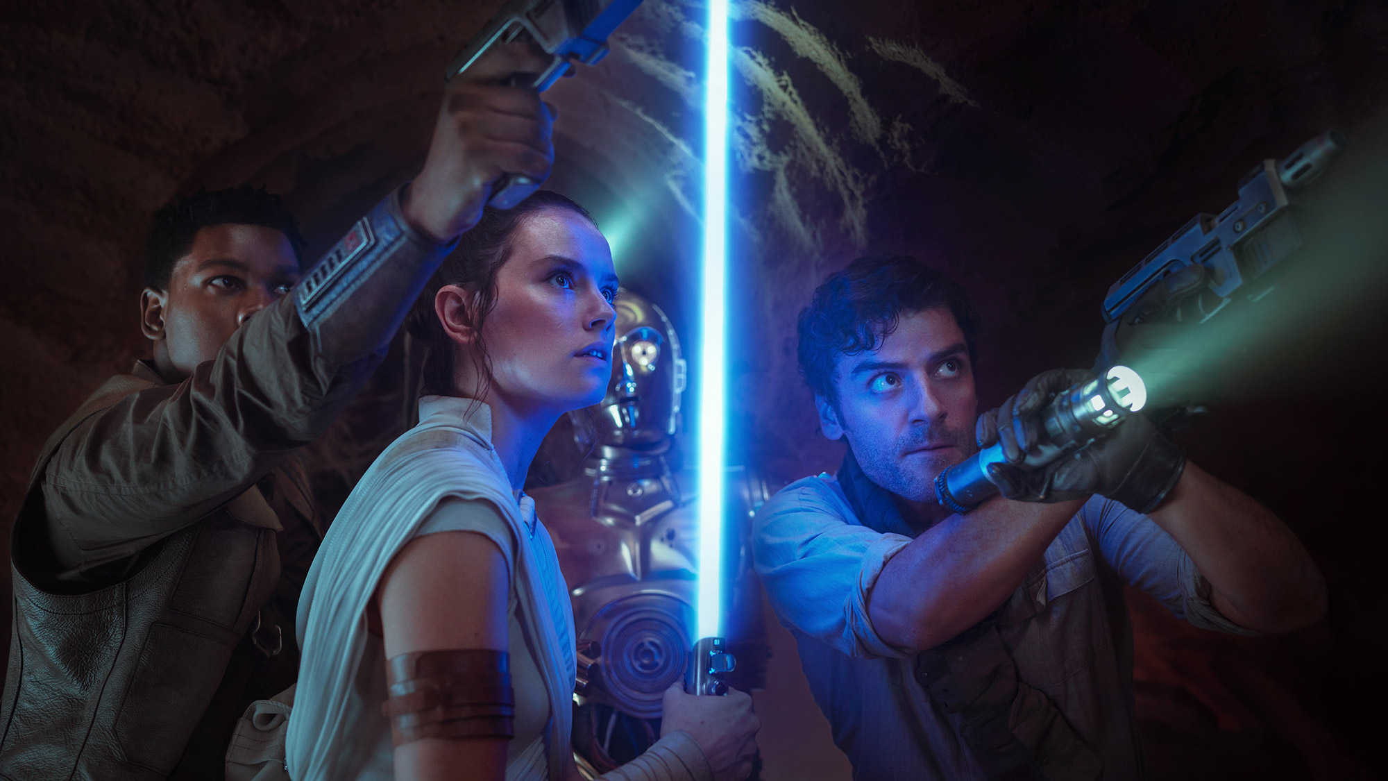 Finn, Rey, C-3PO, and Poe looking at something off-camera in Star Wars Episode IX: The Rise of Skywalker