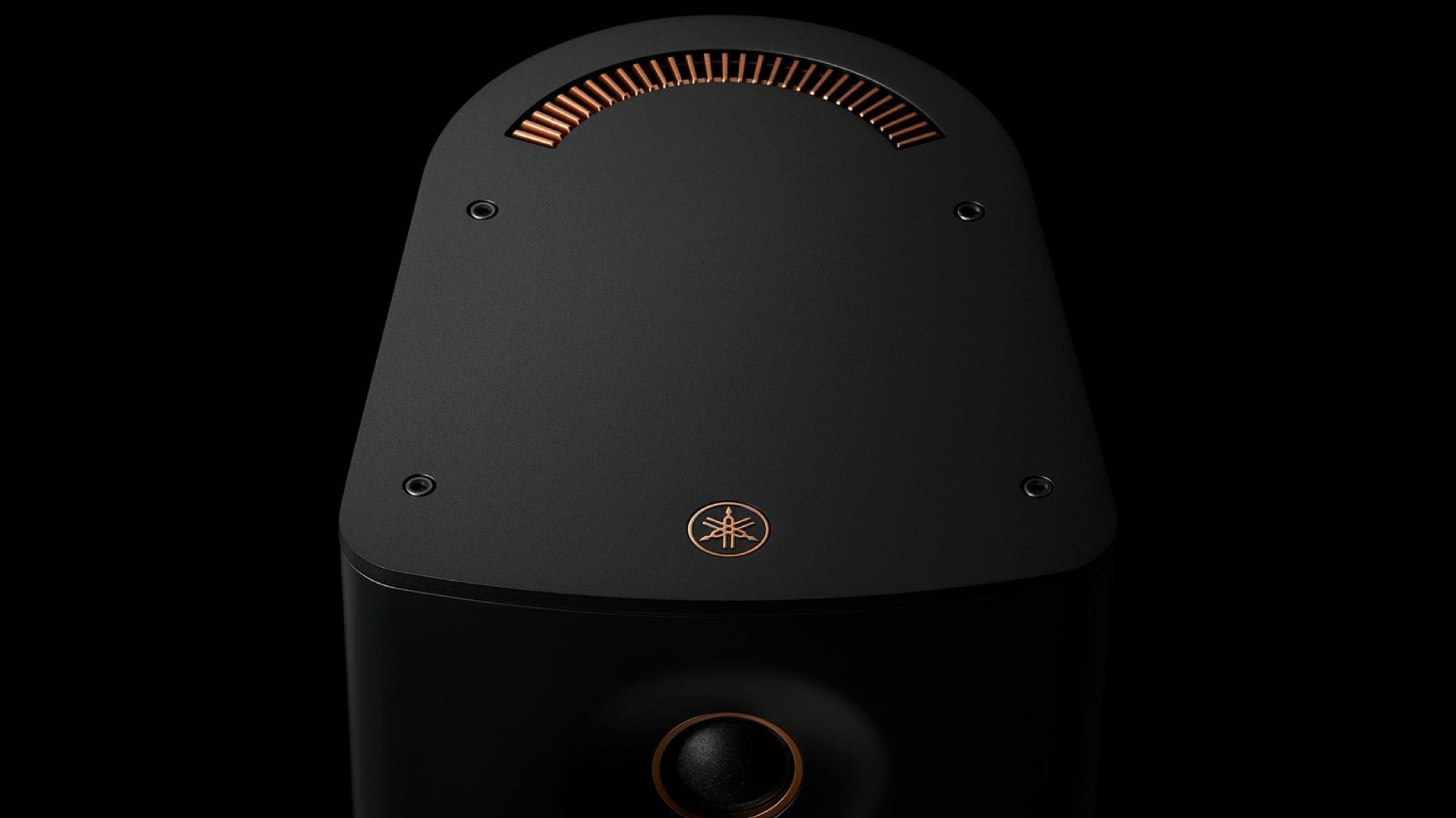 Close up of the Yamaha NX-70A speaker in black, against a black background