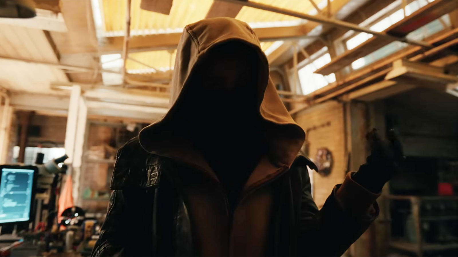 A hooded individual whose face is shrouded in shadow standing in an apartment in Spider-Man: Brand New Day