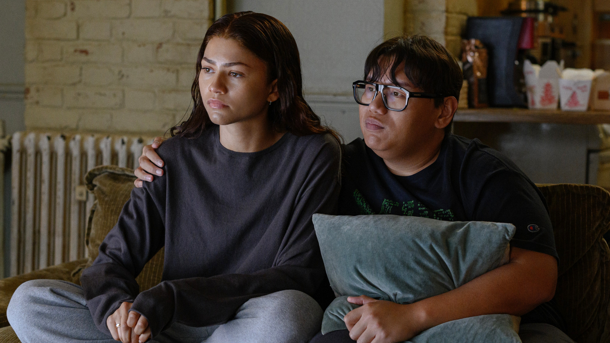 M.J. and Ned looking concerned as they watch a TV in Spider-Man: Brand New Day