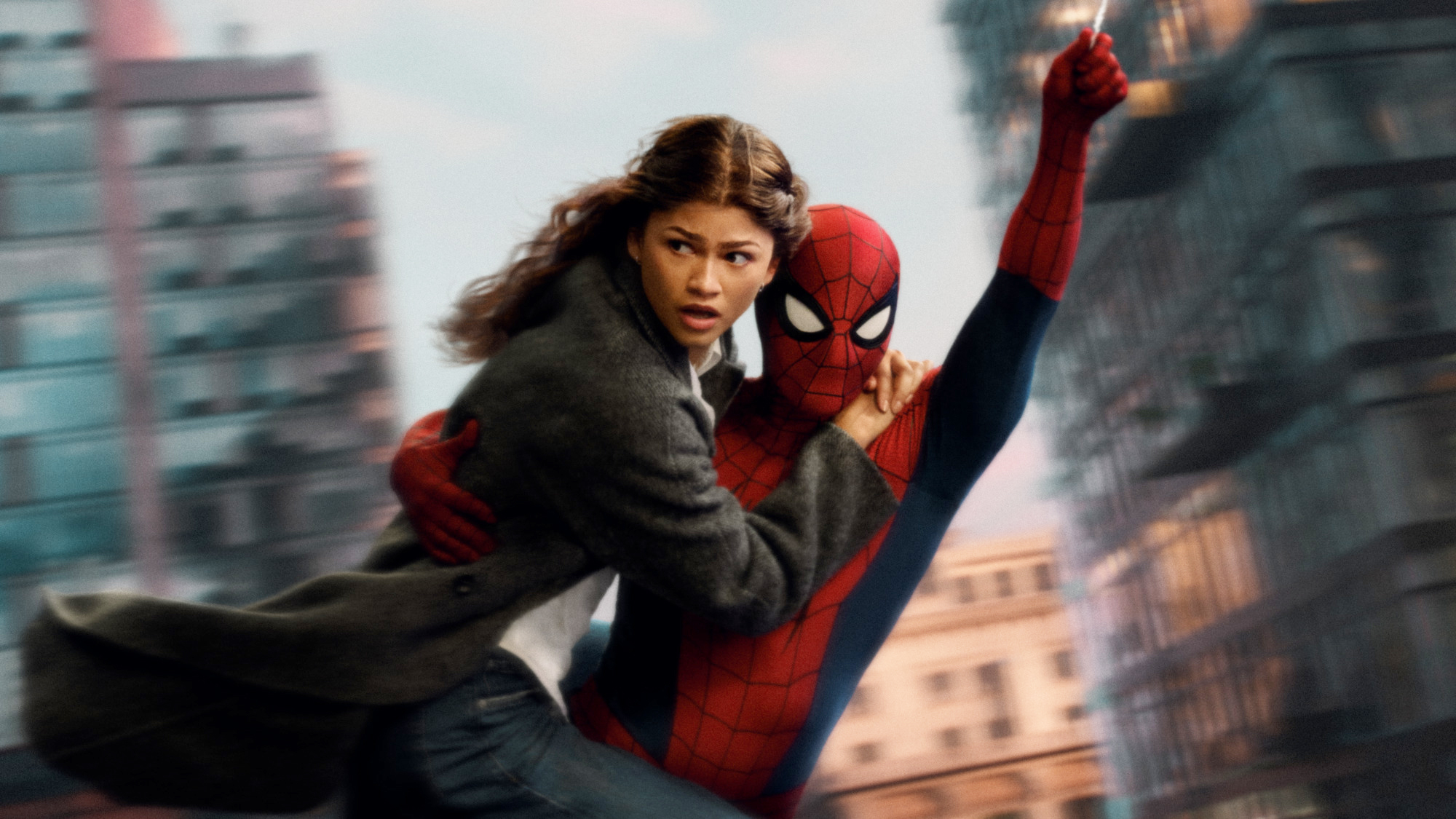 M.J looking scared as she clings to Spider-Man as they swing through New York City in Spider-Man: Brand New Day
