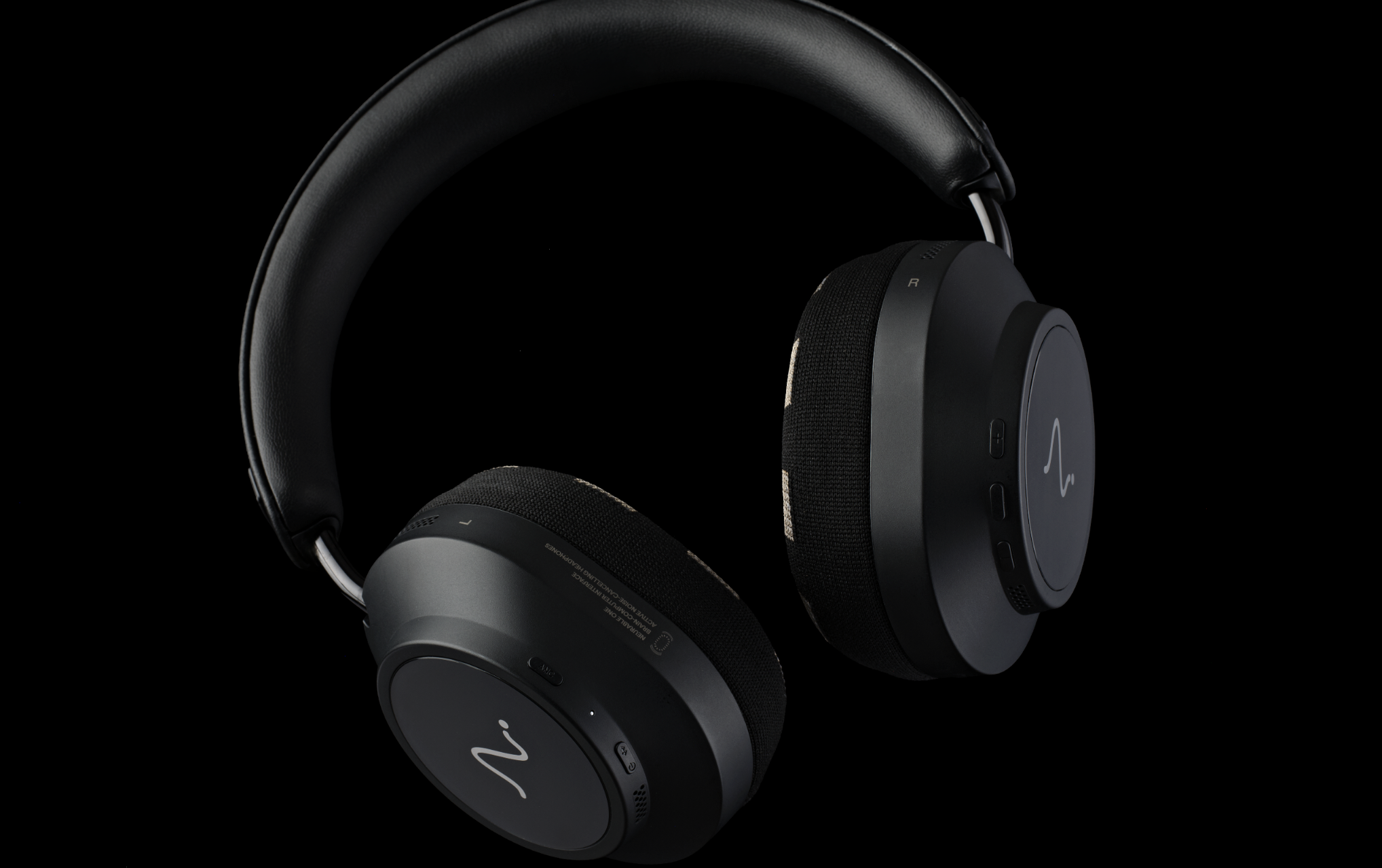 Neurable One headphones on a wooden desk, or on a black background, showing the ear cups